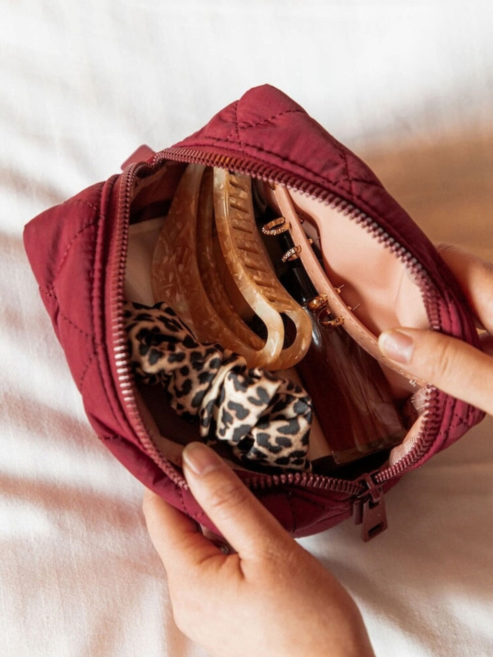 Interior of a berry coloured makeup bag