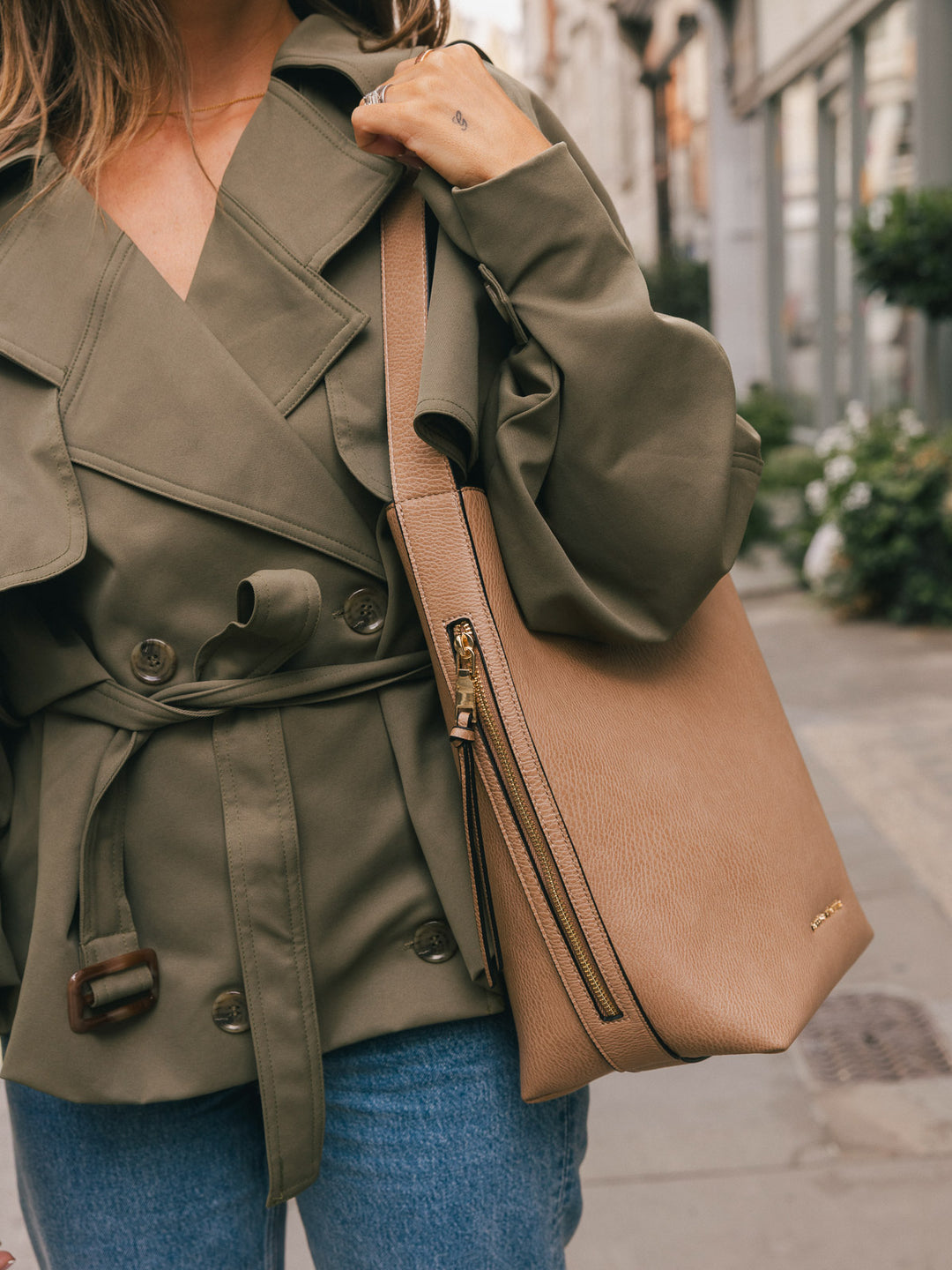 Close-up side view of the Poppy & Peonies Bucket Bag in Taupe, highlighting the side zipper pocket and shoulder strap.