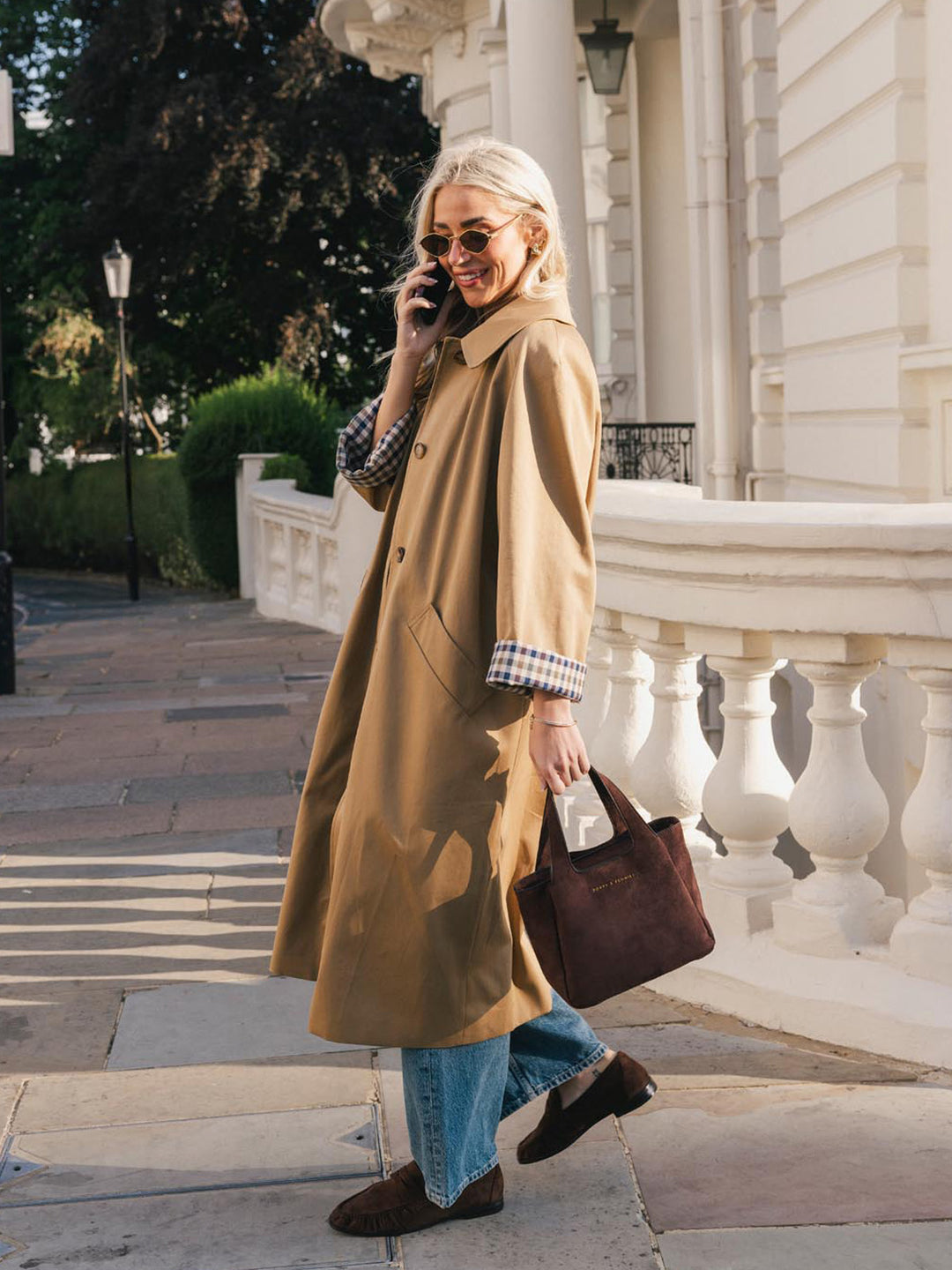 Poppy & Peonies The Pick Me Up Tote in Espresso Suede carried by the top handles, paired with a casual trench coat and denim outfit.