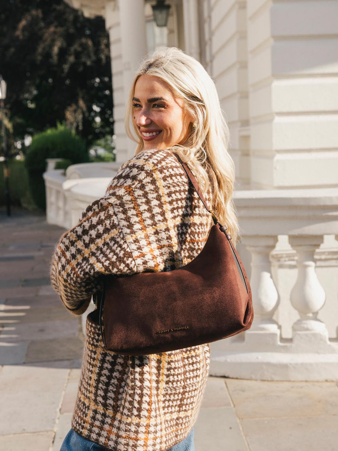 Poppy & Peonies The Sunday Bag in Espresso Suede worn over the shoulder, highlighting the soft suede texture, spacious silhouette and comfortable strap.