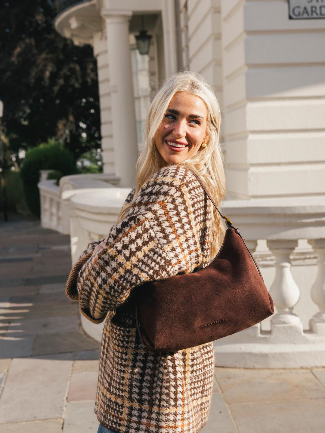 Poppy & Peonies The Sunday Bag in Espresso Suede worn over the shoulder outdoors, highlighting its roomy silhouette and rich espresso suede finish.