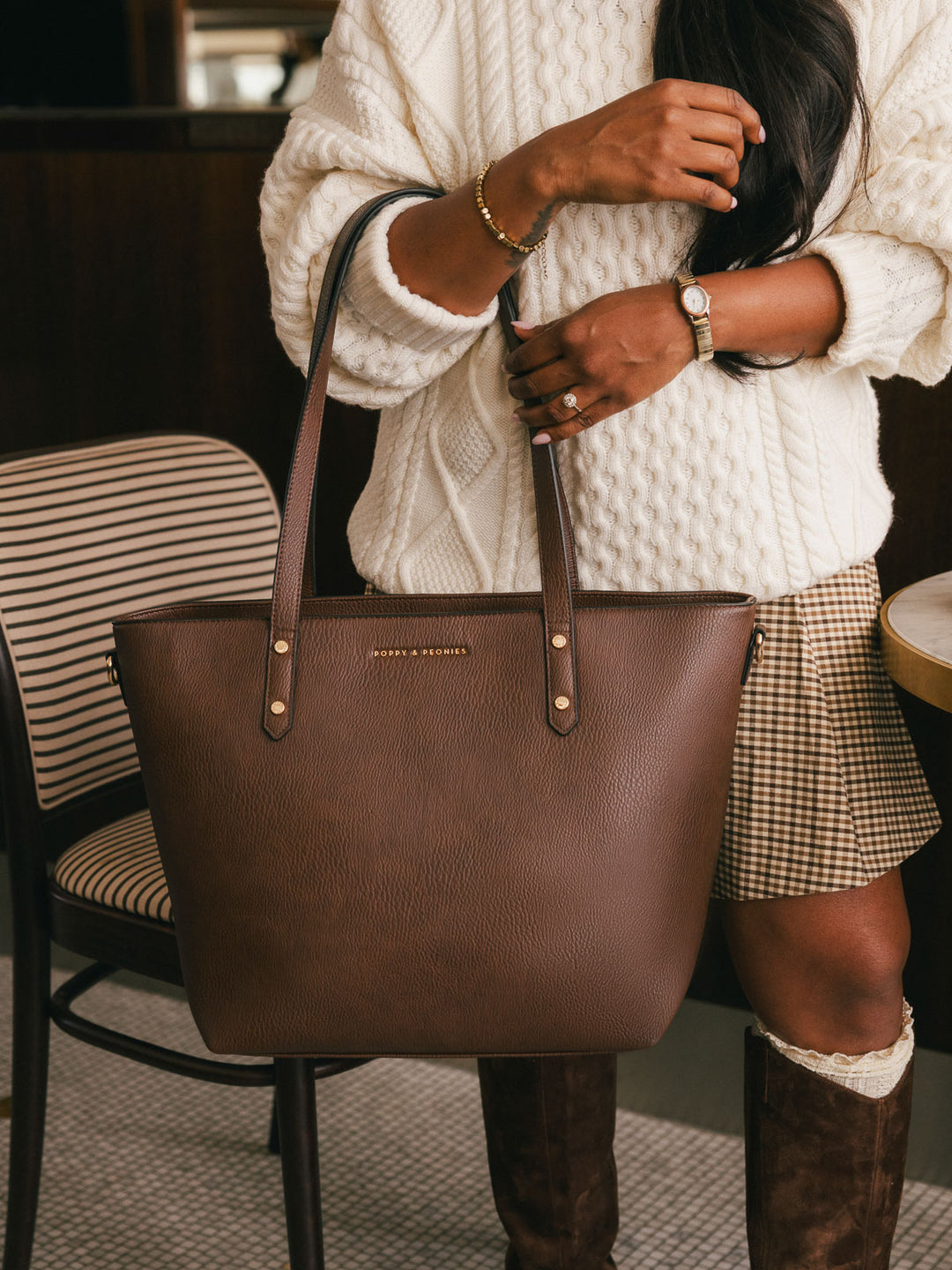 Close-up product-focused shot of the Poppy & Peonies Go-Getter Tote in Espresso carried by its shoulder straps, highlighting the structured silhouette and spacious design.