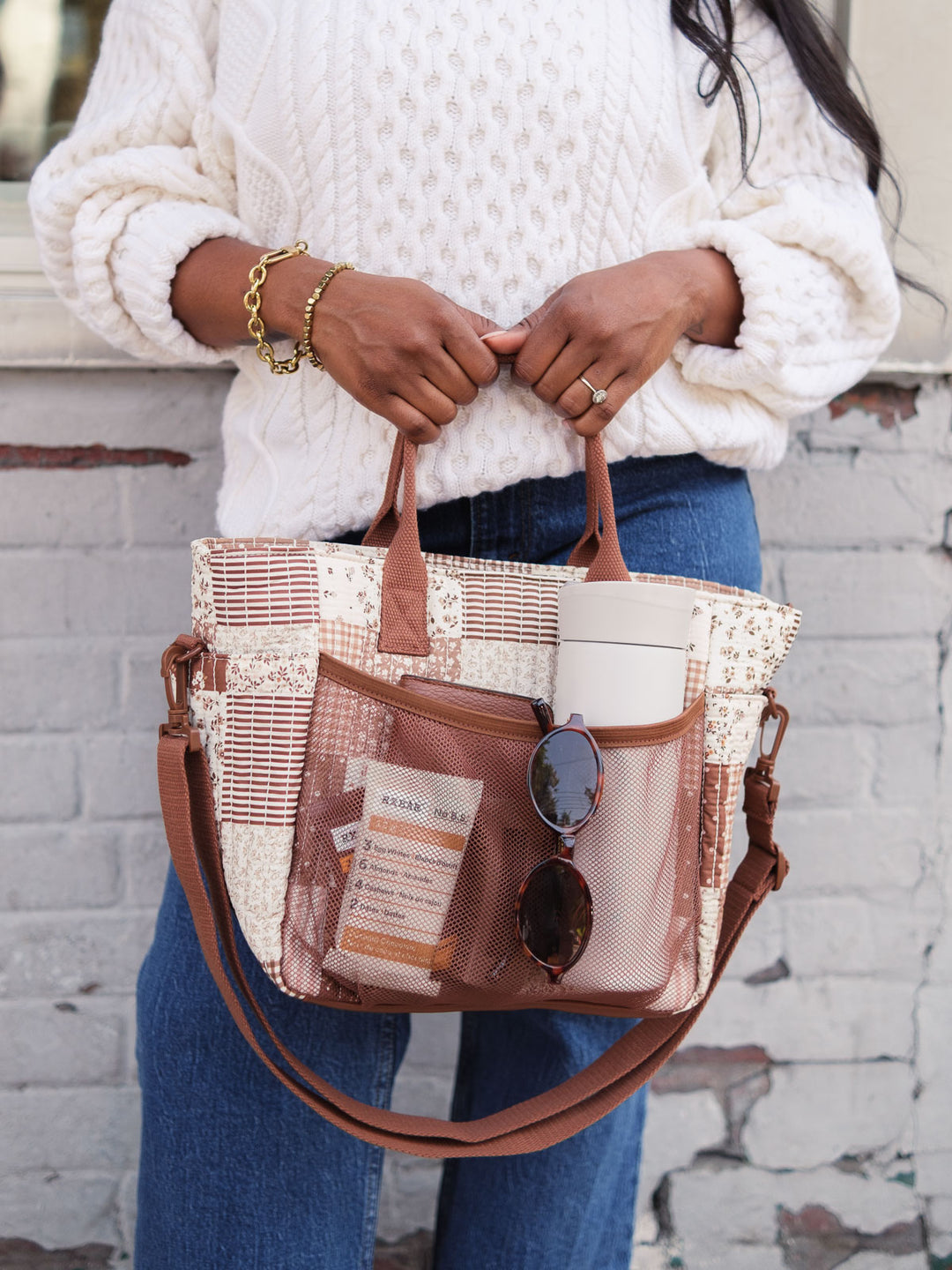 Poppy & Peonies The Lunch Club Lunch Bag in Brown Patchwork with exterior pockets holding a water bottle and essentials.