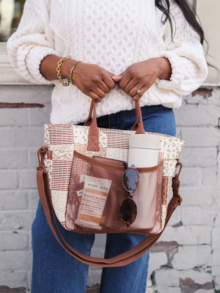 Poppy & Peonies The Lunch Club Lunch Bag in Brown Patchwork with exterior pockets holding a water bottle and essentials.