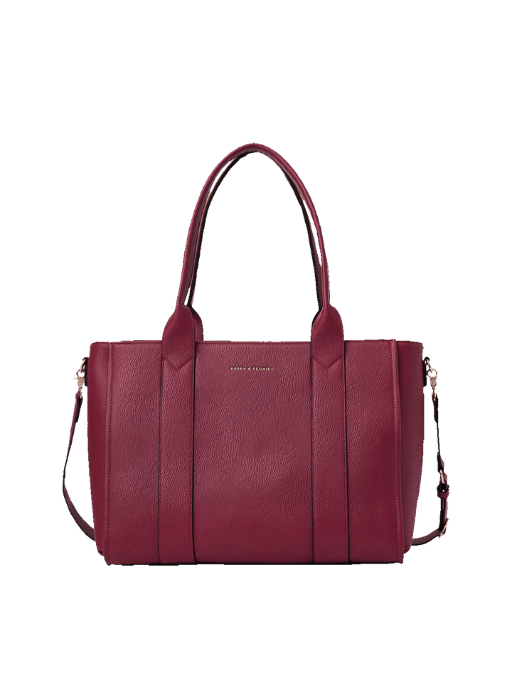 Poppy and Peonies Multitasker in Berry, front view of a structured berry-colored pebbled vegan leather tote bag featuring dual long shoulder handles, a detachable adjustable shoulder strap, gold-tone hardware, vertical panel detailing, and a subtle gold-tone logo.
