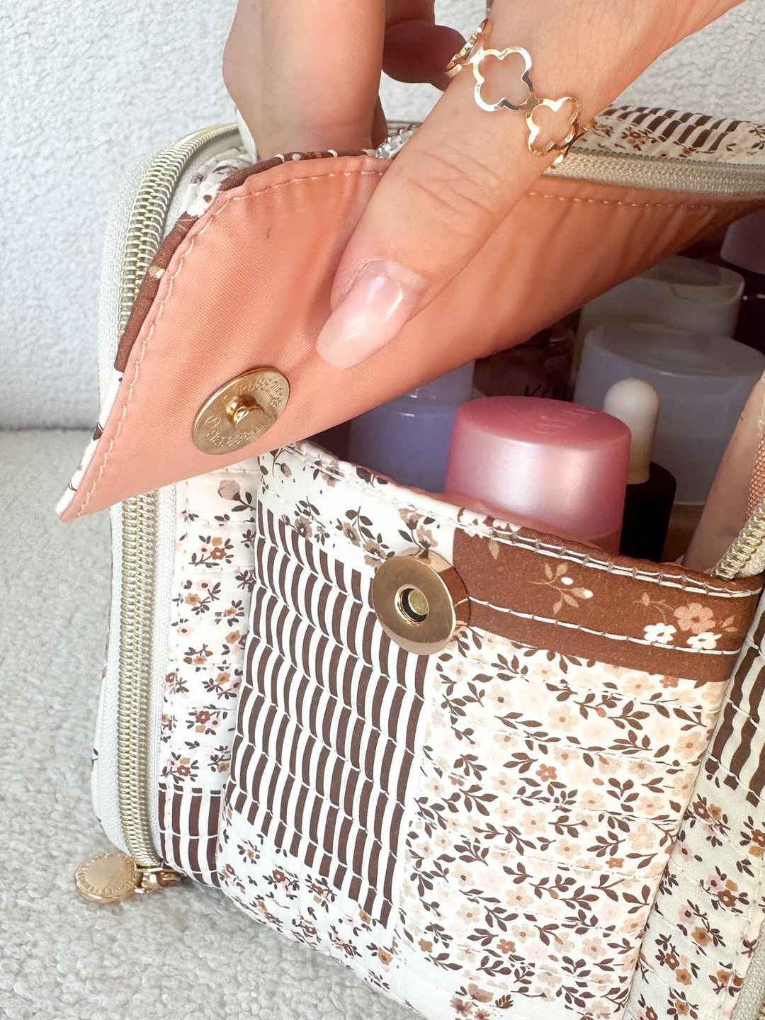 Poppy & Peonies The Routine Cosmetic Case in Brown Patchwork exterior pocket with magnetic closure.