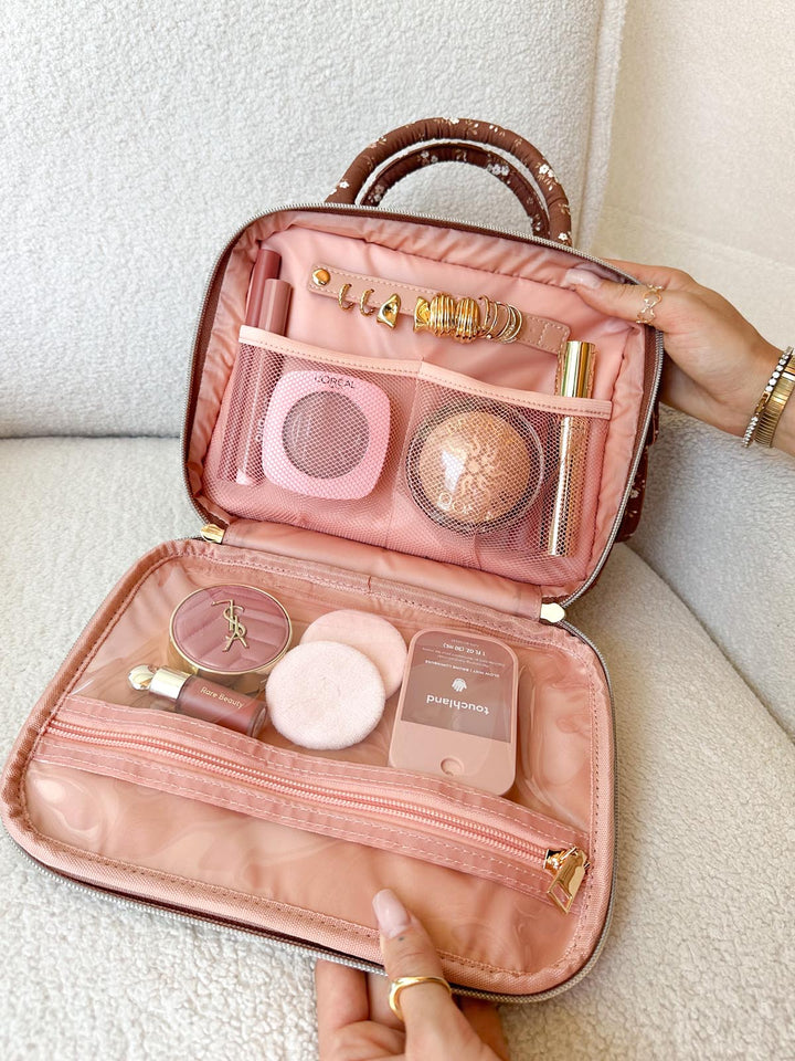 Poppy & Peonies The Routine Cosmetic Case in Brown Floral open with organized cosmetics and jewelry.