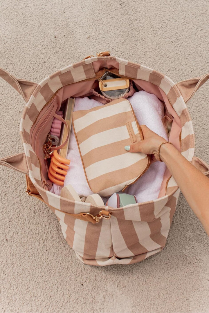 Poppy and Peonies of a cosmetic bag in camel stripe in a beach bag