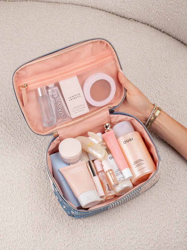 Poppy & Peonies Getaway Cosmetic Set in Navy Patchwork open with skincare and beauty essentials inside.