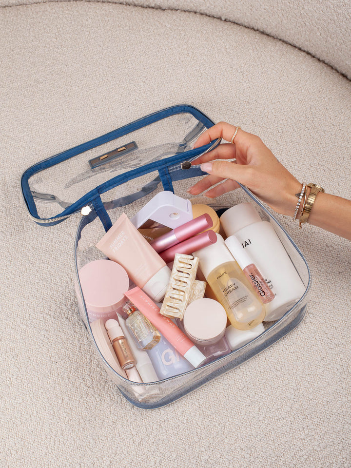 Poppy & Peonies Getaway Cosmetic Set in Navy Patchwork clear cosmetic case filled with beauty essentials.