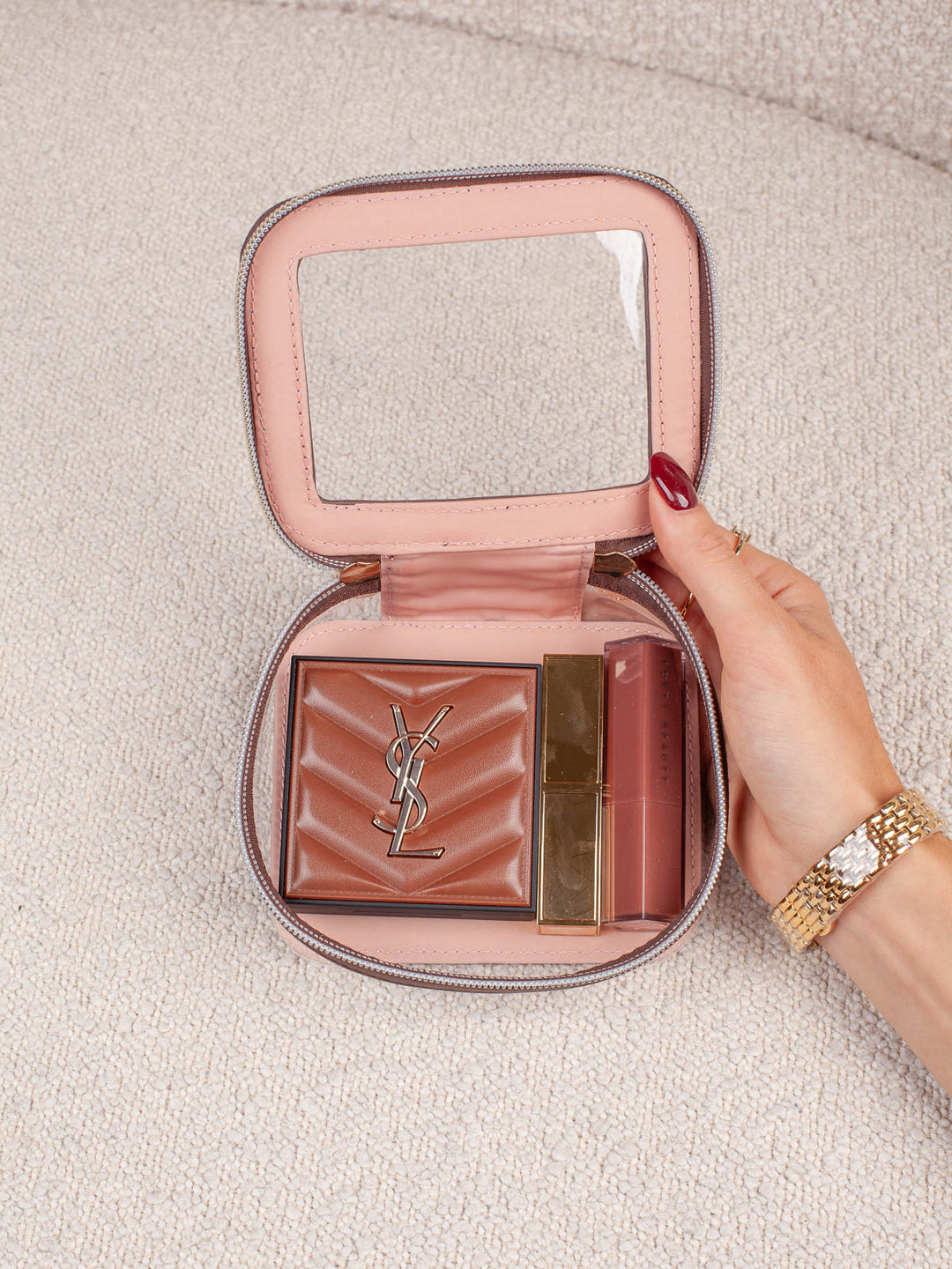 Interior lifestyle shot of the Mini I See You in Espresso, shown open and filled with beauty essentials. Highlights the clear-view lid, compact interior storage, and easy visibility of everyday cosmetics and accessories.