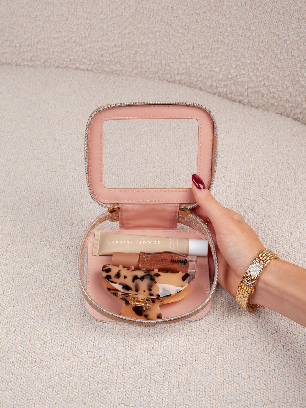 Interior lifestyle shot of the Mini I See You in Taupe, shown open and filled with beauty essentials. Highlights the clear-view lid, compact interior storage, and easy visibility of everyday cosmetics and accessories.