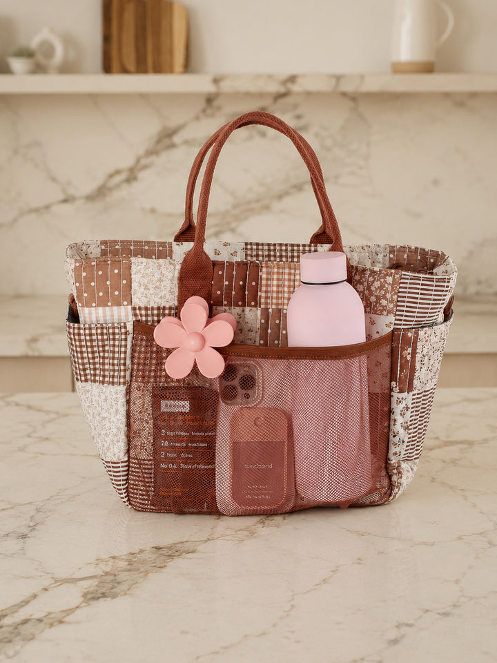 Poppy & Peonies The Lunch Club Lunch Bag in Brown Patchwork with water bottle and everyday essentials in exterior pockets.