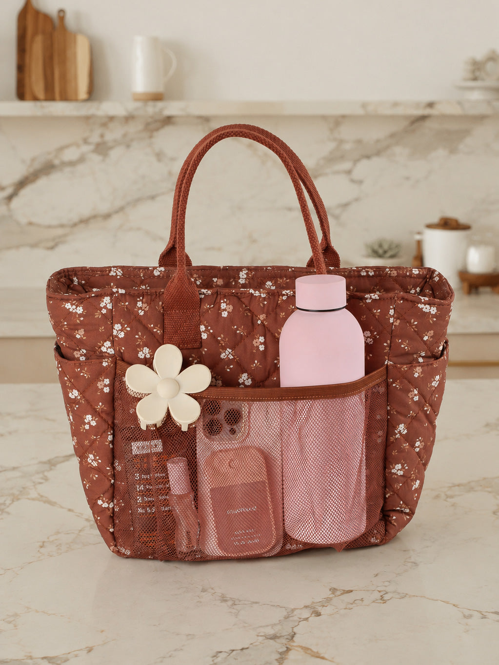 Poppy & Peonies The Lunch Club Lunch Bag in Brown Floral with water bottle and everyday essentials in exterior pockets.