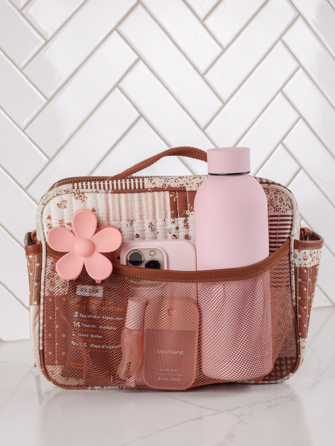 Poppy & Peonies The Lunch Box in Brown Patchwork with water bottle and essentials in exterior pockets.