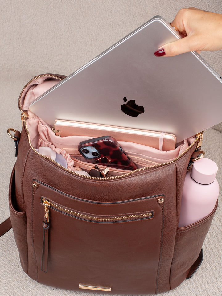 Poppy & Peonies Commuter Backpack in Espresso shown holding a laptop, highlighting its spacious interior and practical everyday storage capacity. 