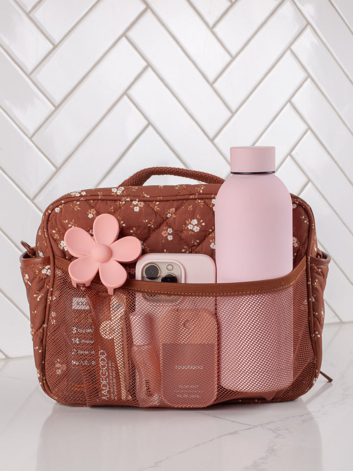 Poppy & Peonies The Lunch Box in Brown Floral with water bottle and essentials in exterior pockets.