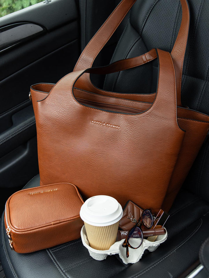 Poppy & Peonies The Companion Tote Bundle in Chestnut lifestyle car scene, featuring the tote and Pretty Connected Case alongside everyday essentials.