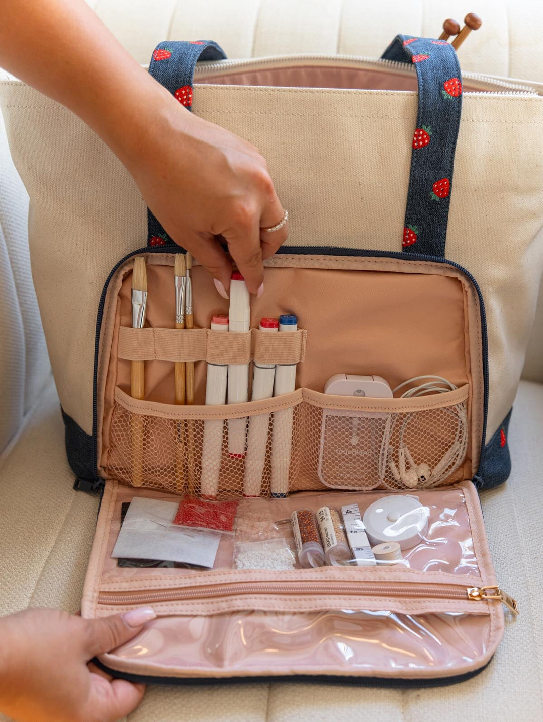 Poppy & Peonies Analog Tote in Strawberry Denim organizational compartment open, showing elastic loops, mesh pockets and clear zippered storage holding craft and tech essentials.