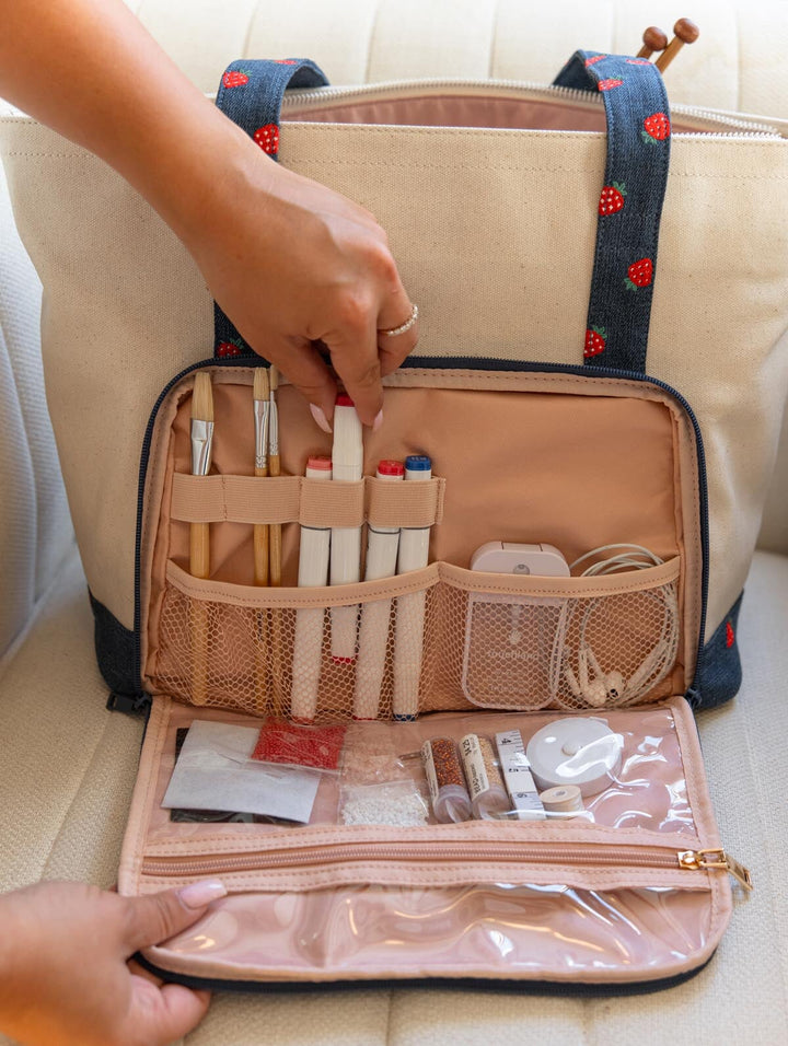 Poppy & Peonies Analog Tote in Strawberry Denim organizational compartment open, showing elastic loops, mesh pockets and clear zippered storage holding craft and tech essentials.