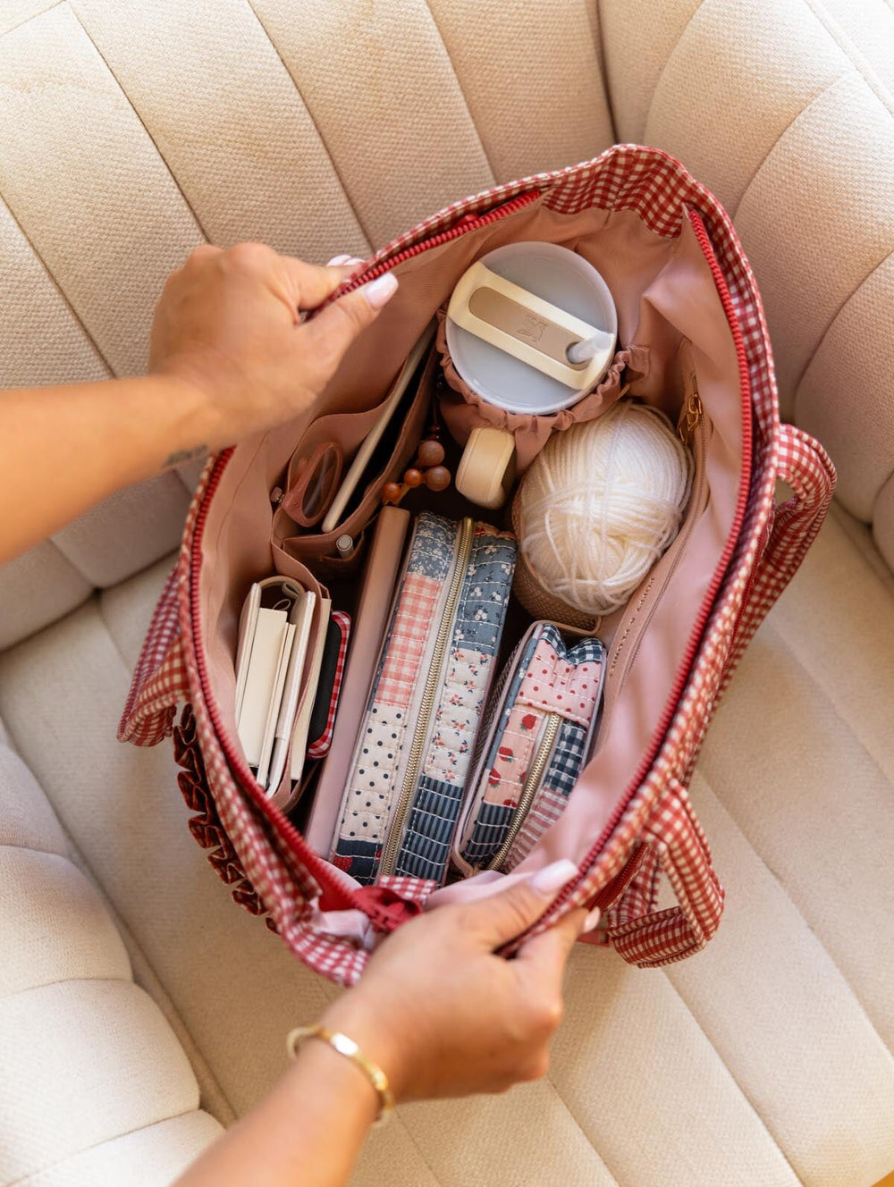 Poppy & Peonies Analog Tote in Heart Berry Gingham open top view, packed with craft and everyday essentials including yarn, organizational cases, notebooks and a travel mug.