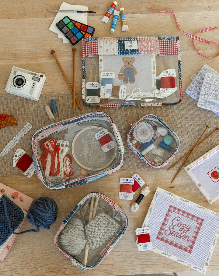 Poppy & Peonies She’s a WIP Bag and Clearly Organized Set in Strawberry Patchwork, styled with knitting, embroidery, needlepoint and art supplies.