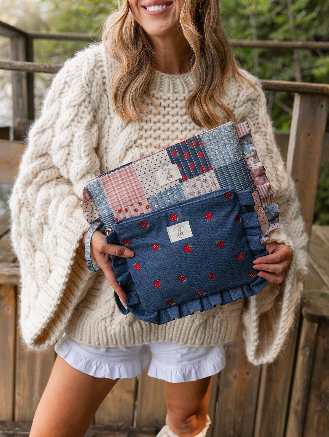 Poppy & Peonies 2-Piece Darling Ruffle Set lifestyle view, featuring the Strawberry Denim ruffled pouch layered with the coordinating Strawberry Patchwork pouch.