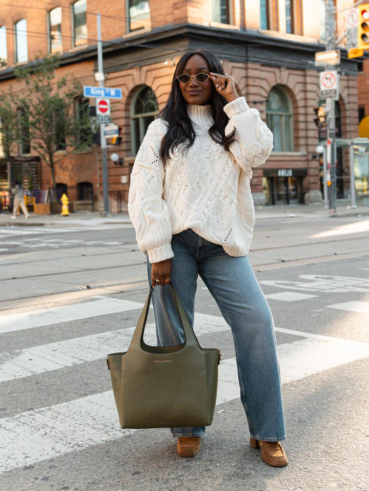 Poppy & Peonies The Companion Tote in Olive full-length lifestyle view, featuring the tote carried by its top handles.