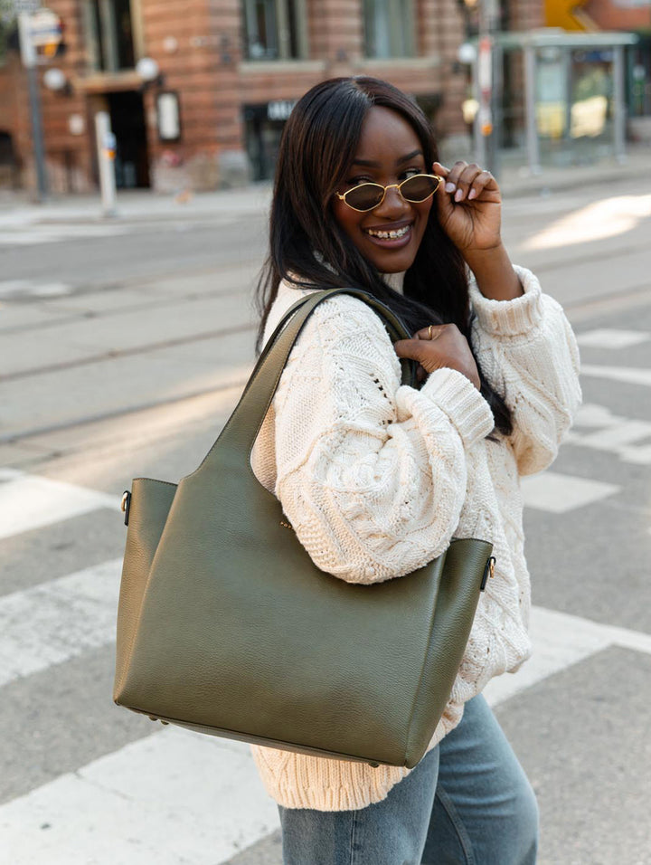 Poppy & Peonies The Companion Tote in Olive lifestyle close-up, showcasing its spacious silhouette worn over the shoulder.