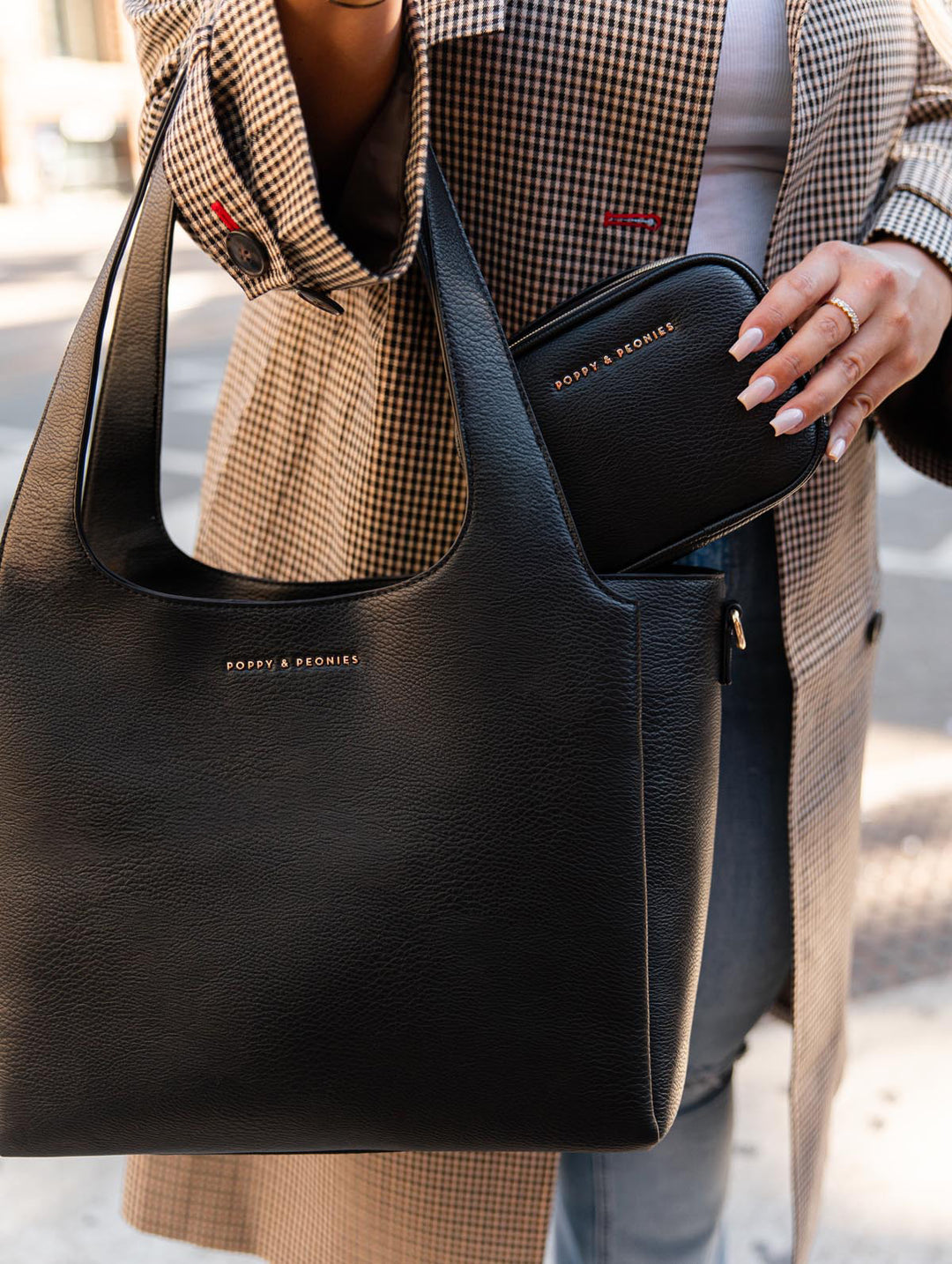 Close-up view of Poppy & Peonies The Companion Tote and Pretty Connected Case in Black, showcasing the coordinating bundle together.