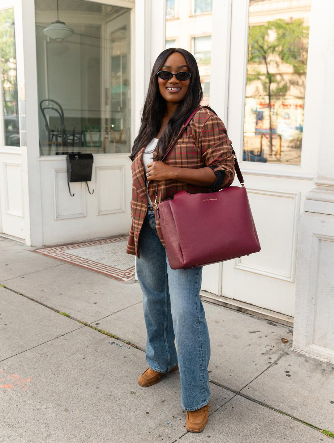 Poppy & Peonies The Companion Tote in Berry worn with the detachable shoulder strap for hands-free carrying.
