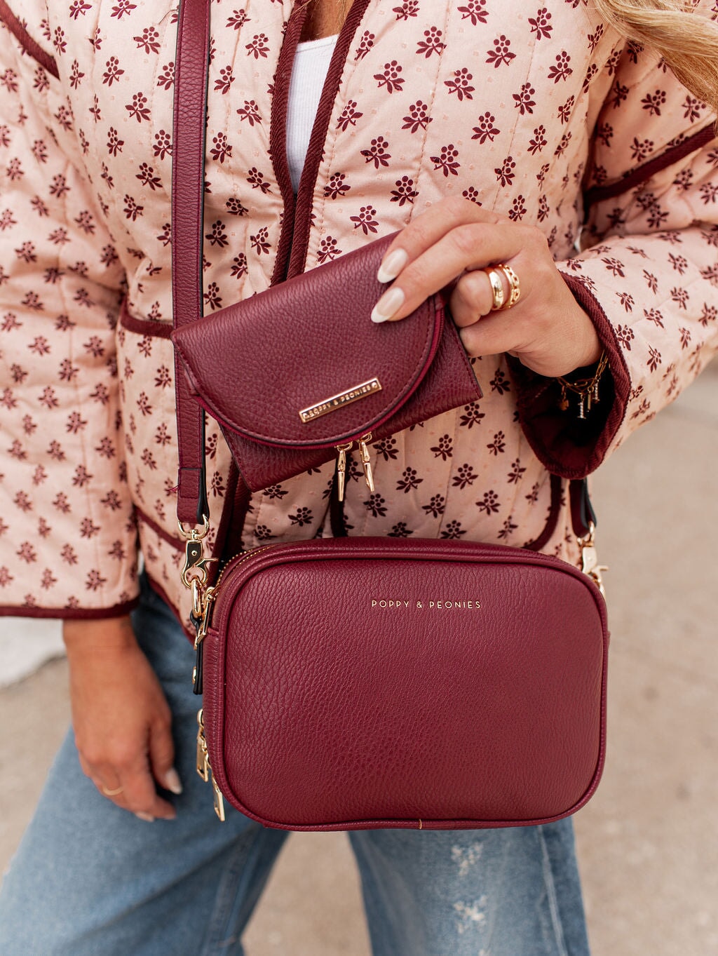 Woman holding a berry coloured vegan leather wallet