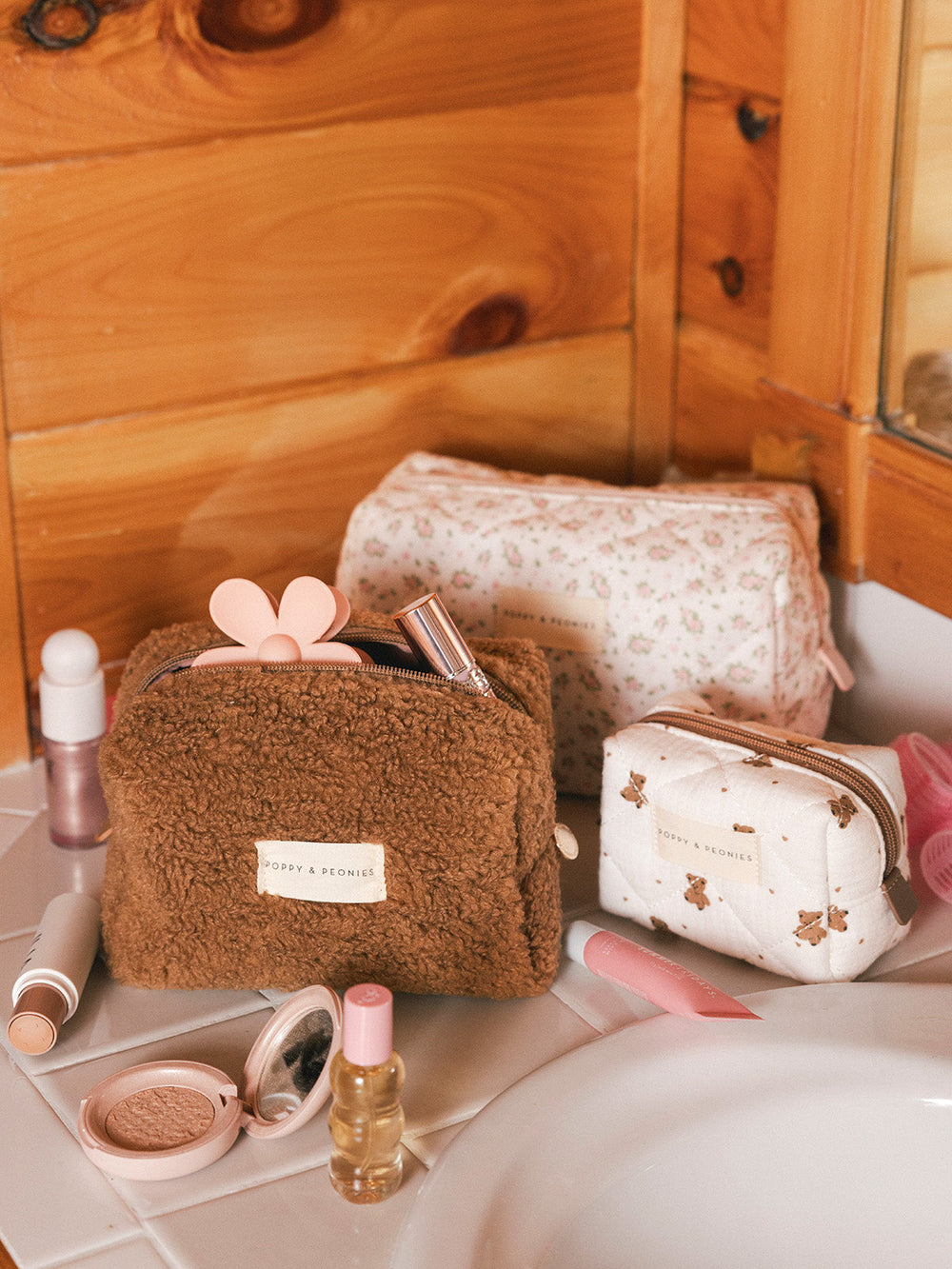 Three cosmetic bags on a bathroom counter