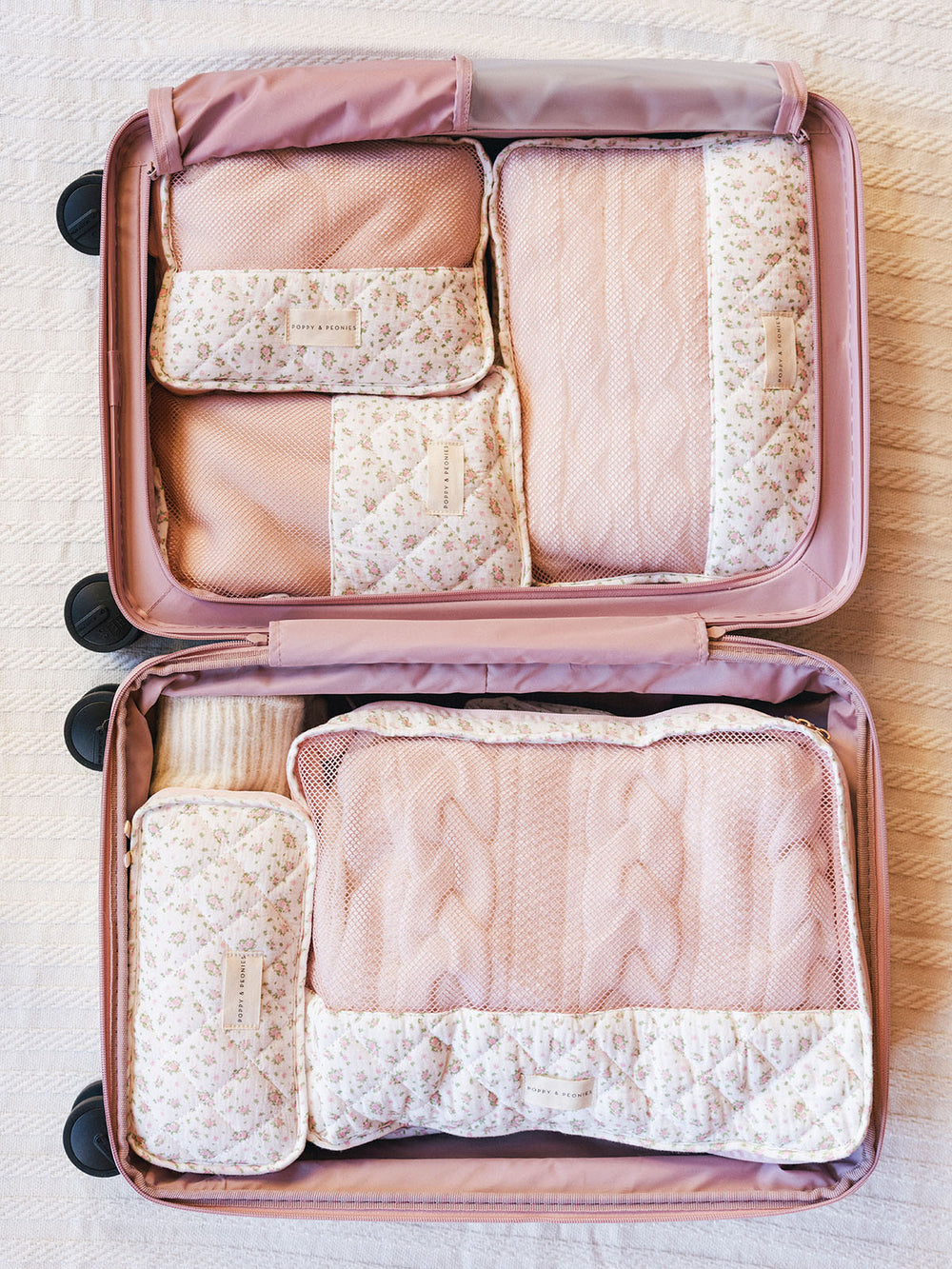 Floral-patterned packing cubes in a suitcase