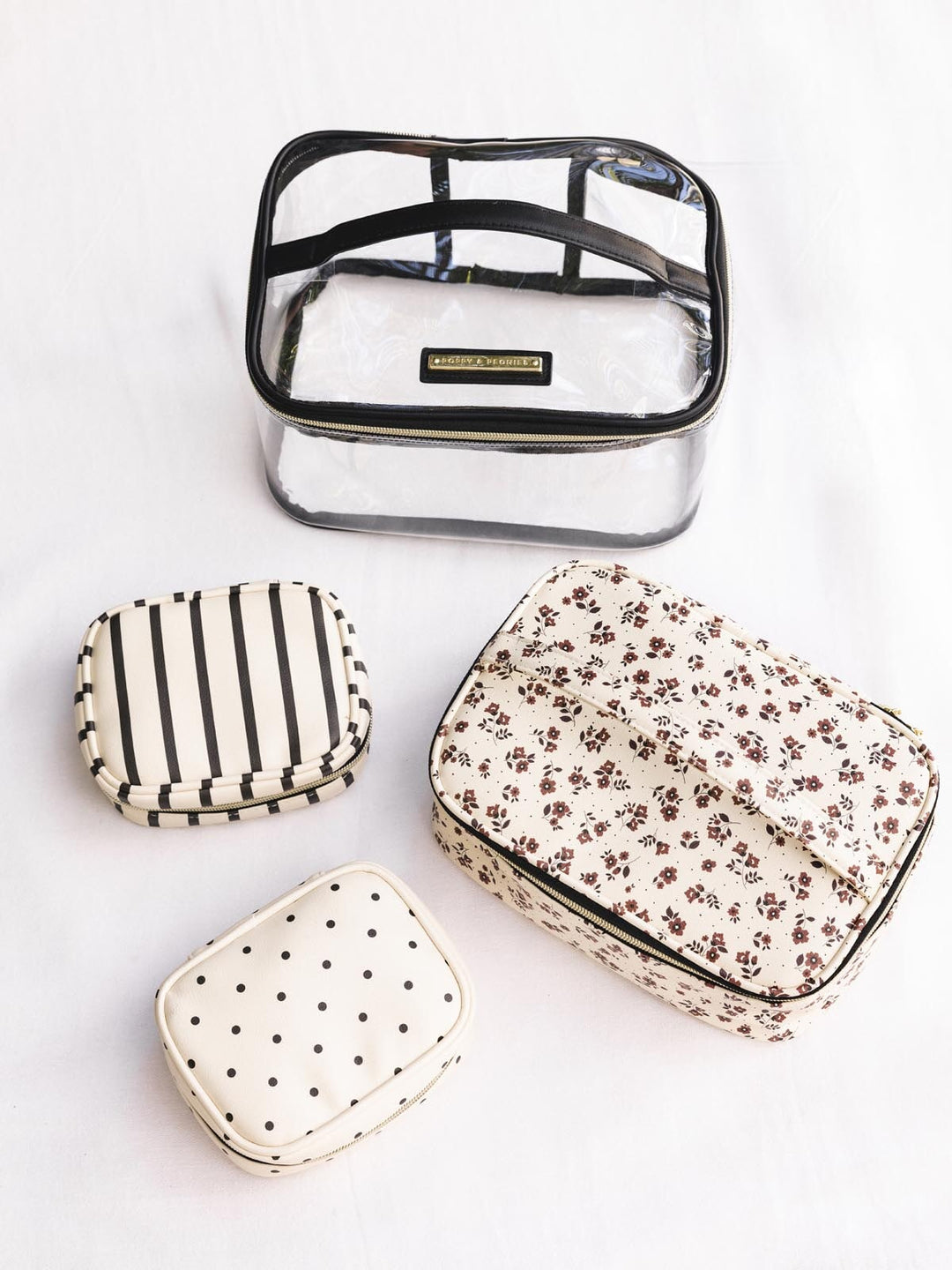 Set of four small cosmetic bags with different patterns on a white background