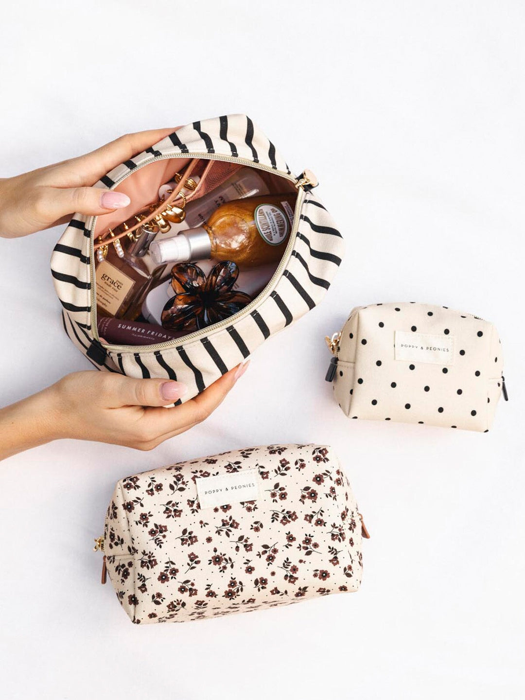 Three cosmetic bags with different designs on a white background