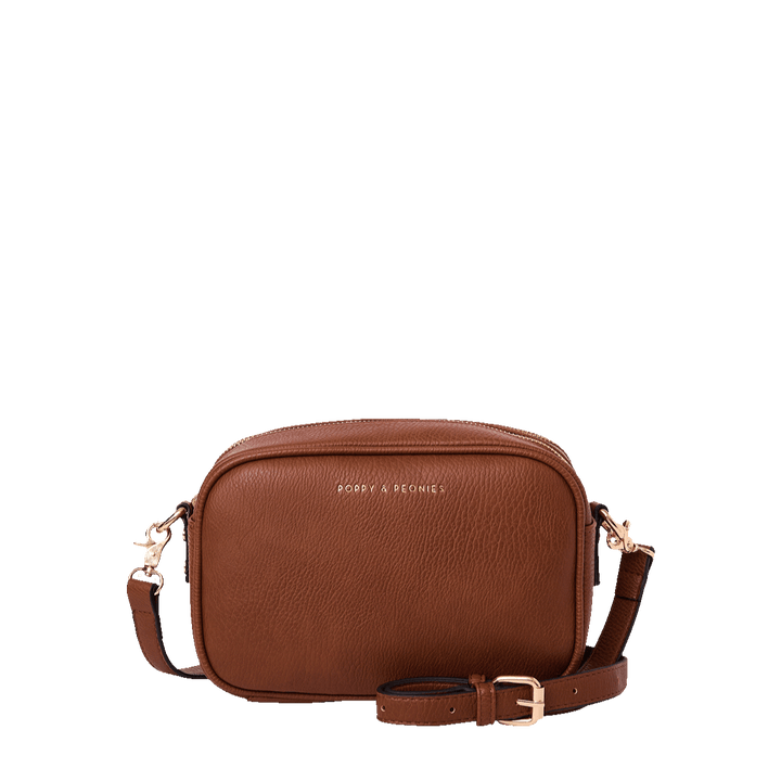 Brown vegan leather crossbody bag on a transparent background
