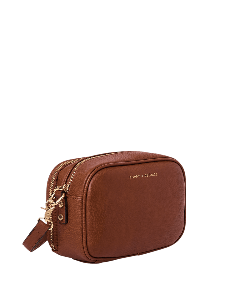 Brown vegan leather crossbody bag with gold zipper on a transparent background