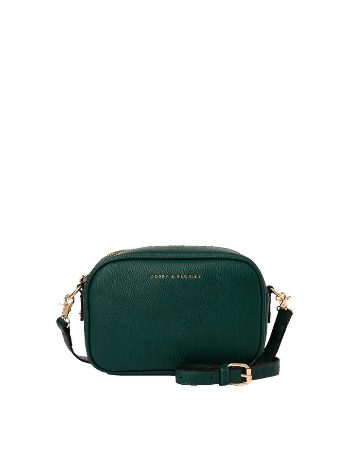 Poppy and Peonies 24/7 Crossbody Heritage Green featuring a compact rectangular crossbody bag with a textured dark green exterior, adjustable shoulder strap, gold-tone hardware, and subtle front logo