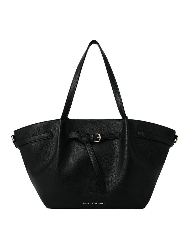Poppy & Peonies The Knot Tote in Black, featuring a black pebbled exterior, decorative belted detail with gold-tone buckle, long shoulder handles, and a spacious trapezoid silhouette.