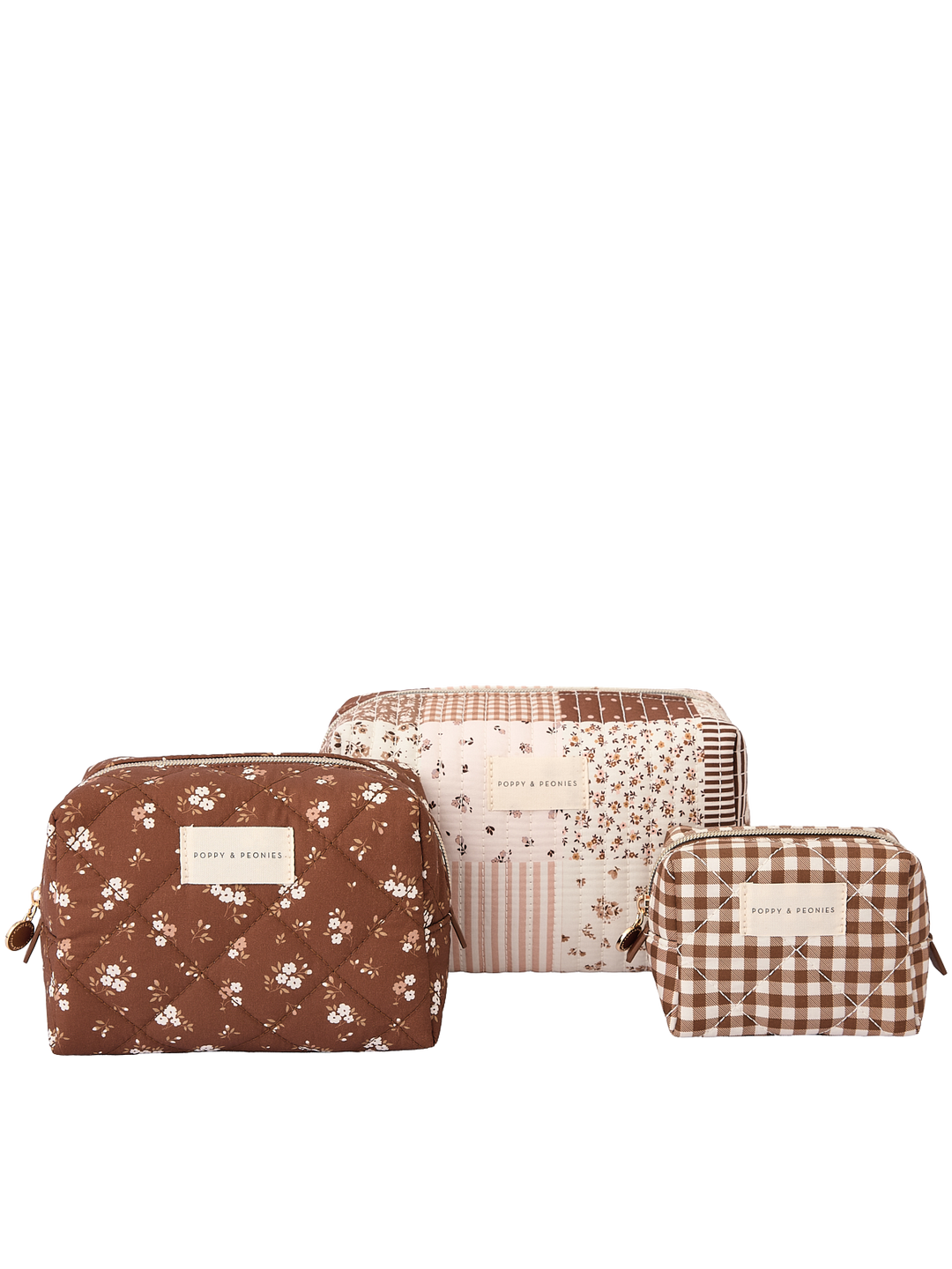 Clean product shot of the Poppy & Peonies Cosmetic Trio in Brown Patchwork, featuring all three coordinating cosmetic cases together: a blue-and-white striped case, a brown patchwork case, and a navy floral case.