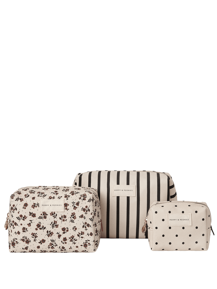 Set of three cosmetic bags with floral, striped, and polka dot patterns.
