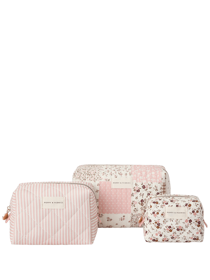 Set of three pink and white patterned cosmetic bags