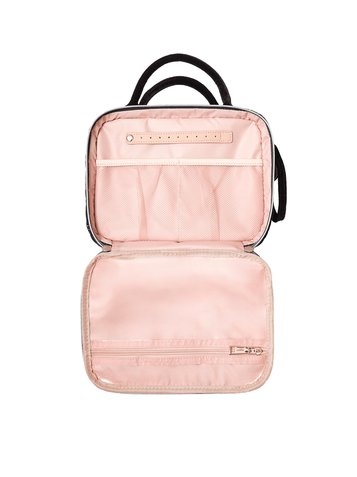 Poppy and Peonies The Routine Cosmetic Black Velvet displayed fully open, showcasing its blush pink interior with elastic storage pockets, a central organizing strap, and spacious compartments for cosmetics and toiletries.