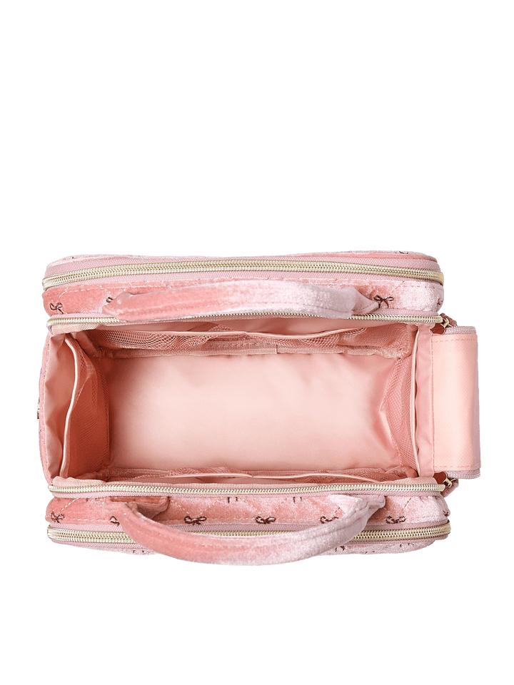 Poppy and Peonies The Routine Cosmetic Pink Velvet displayed open from above, revealing its blush pink interior lining, spacious main compartment, and wide elastic storage band for organizing beauty essentials.
