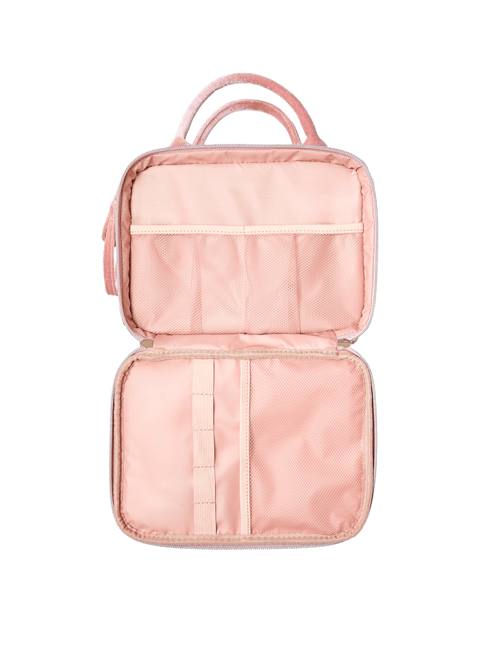 Poppy and Peonies The Routine Cosmetic Pink Velvet displayed fully open, showcasing its blush pink interior with elastic storage pockets, a central organizing strap, and spacious compartments for cosmetics and toiletries.
