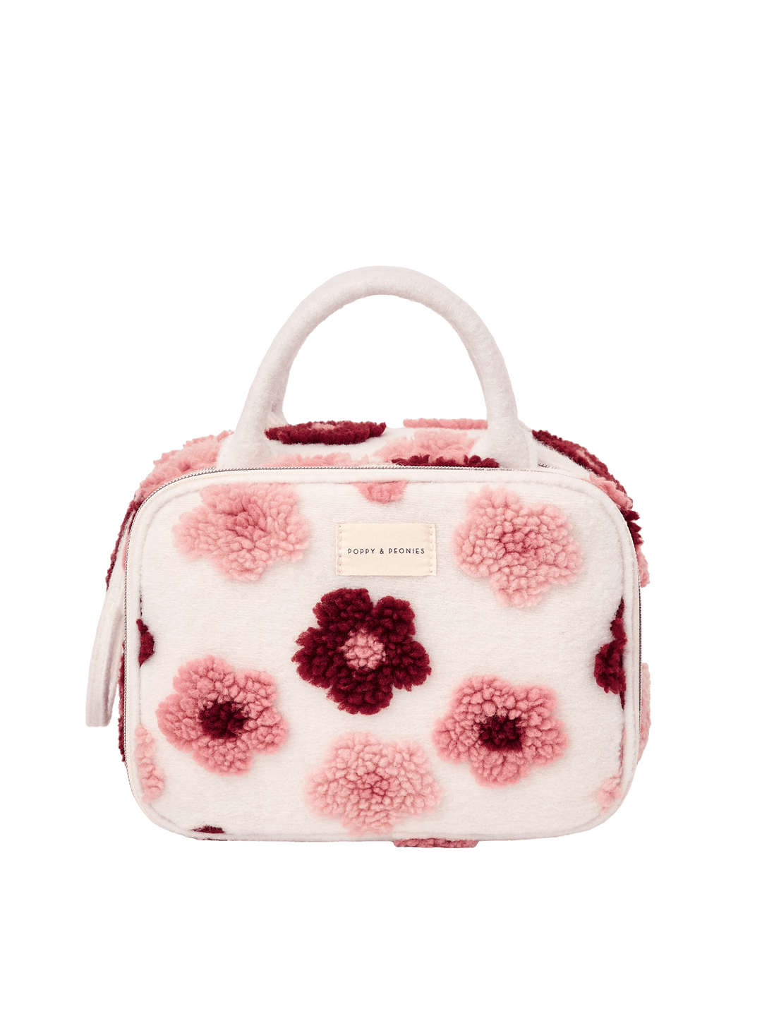 Poppy and Peonies The Routine Cosmetic Floral featuring a structured rounded rectangular silhouette, soft cream-colored exterior with plush pink and berry floral patterns, dual cream top handles, zip-around closure, and rectangular Poppy and Peonies logo plate on the front.
