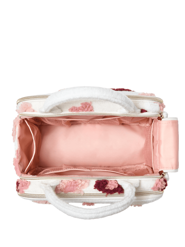 Poppy and Peonies The Routine Cosmetic Floral displayed open from above, revealing its blush pink interior lining, spacious main compartment, and wide elastic storage band for organizing beauty essentials.