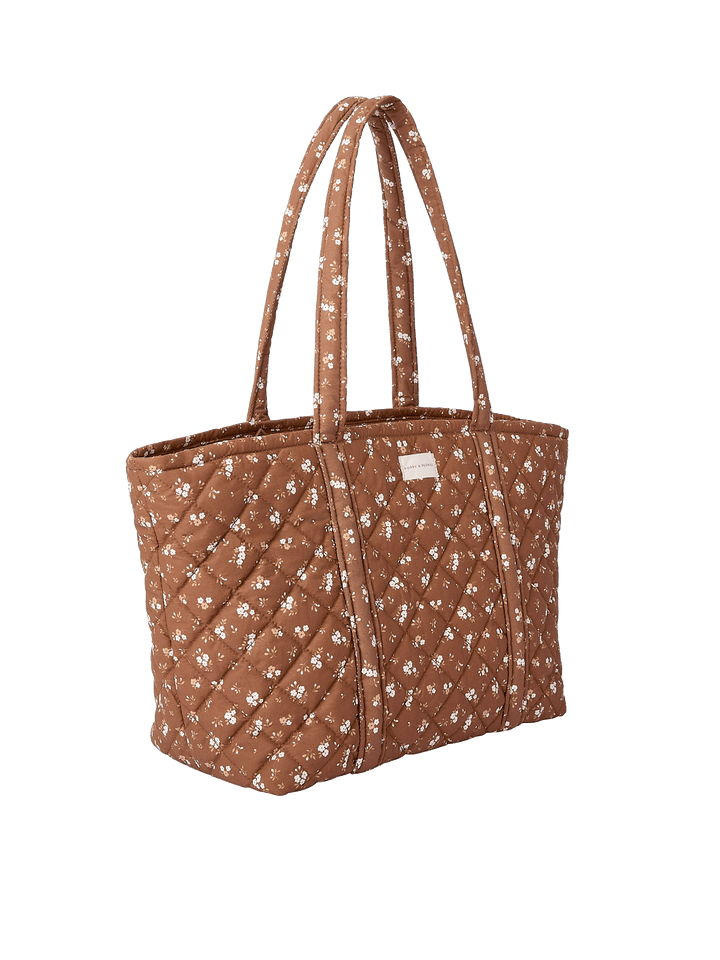 Side profile of the Daydreamer Tote in Brown Floral showing structured quilted design