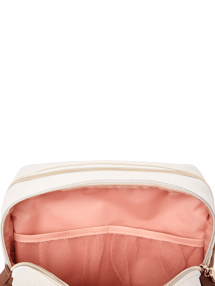 Poppy & Peonies The Double Take Cosmetic in Chestnut, close-up of the blush-pink interior showing a wide slip pocket and mesh organizer pocket.